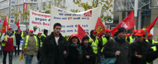 Demo in Dortmund mit roten Fahnen und Transparenten.