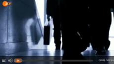 Aus dem Video: dunkel gehalten - Männerbeine, Hand mit Aktenkoffer.